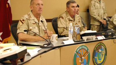 During a daily update United States Central Command Commanding General Tommy R. Franks, left, and his deputy Commander in Qatar, LT. General John Abigail meet with Franks senior staff on March 25th to discuss with his combatant commanders the progress of Operation Iraqi Freedom at the Central Commands forward headquarters in Qatar. (Photo by Navy Petty Officer Gary P. Bonaccorso)